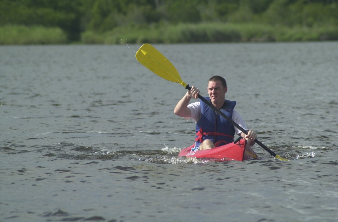 MARINE CORPS BASE CAMP LEJEUNE, N.C. - Seaman Charles Canaan, a corpsman at the Naval Hospital Camp Lejeune, cruises the New River in a kayak during the Great American Backyard Camp Out at the Brewster Recreation Area here June 24. Several single Marines and families got a chance to get out doors, connect with nature and have a little well deserved fun during the Great American Backyard Camp Out at the Brewster Recreation Area June 24-25. The camp out is a national event that is meant to encourage people to get out doors even if it is just in their backyard. (Official U.S. Marine Corps photo by Lance Cpl. Brandon R. Holgersen)(released)