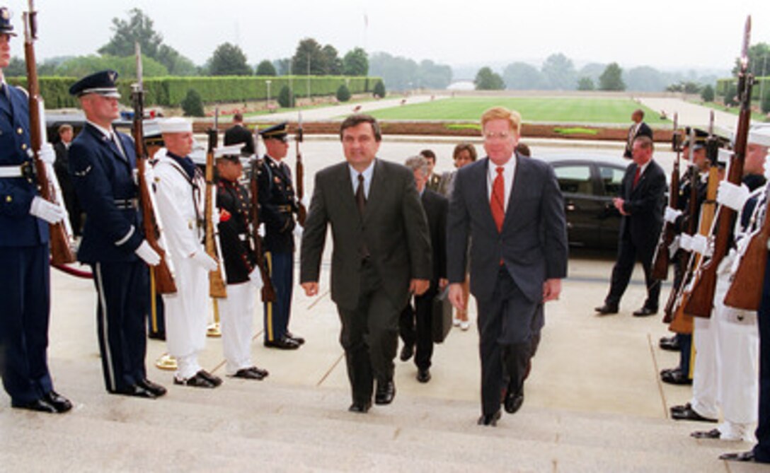 Albanian Prime Minister Ilir Meta (left) is escorted through an honor cordon and into the Pentagon by Deputy Secretary of Defense Rudy de Leon (right) on Aug. 24, 2000. Meta and de Leon will meet to discuss regional security issues. 