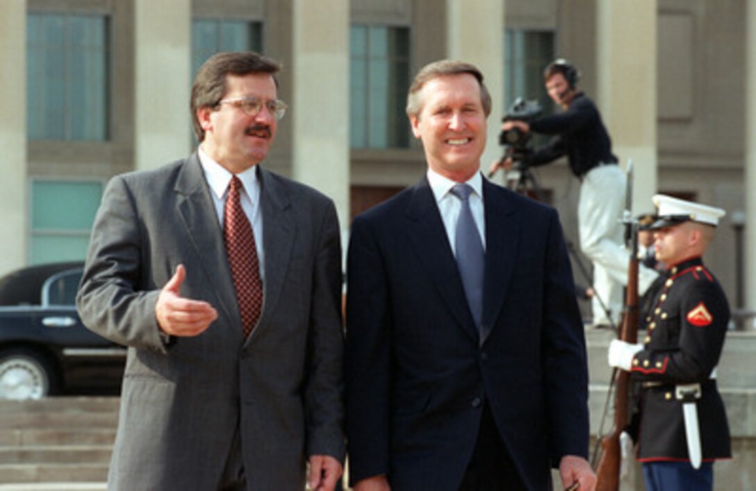Secretary of Defense William S. Cohen (right) escorts Polish Minister of National Defense Bronislaw Komorowski to the Pentagon parade field for a military full honors arrival ceremony on Nov. 8, 2000. Cohen and his senior policy advisors will later meet with Komorowski and his delegation to discuss a broad range of security issues of interest to both nations. 