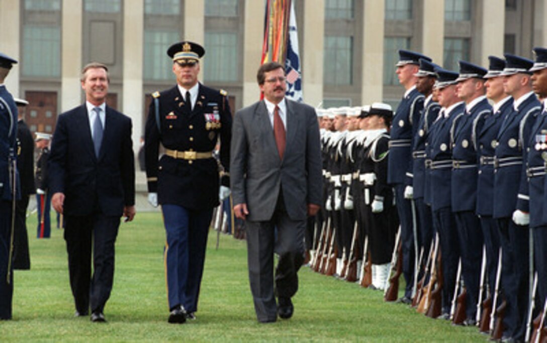 Polish Minister of National Defense Bronislaw Komorowski (right) is escorted by Commander of Troops Col. Thomas M. Jordan (center), U.S. Army, and Secretary of Defense William S. Cohen (left) as he inspects the joint services honor guard at the Pentagon during a military full honors arrival ceremony in his honor on Nov. 8, 2000. Komorowski and his delegation will later meet with Cohen and his senior policy advisors to discuss a broad range of security issues of interest to both nations. 