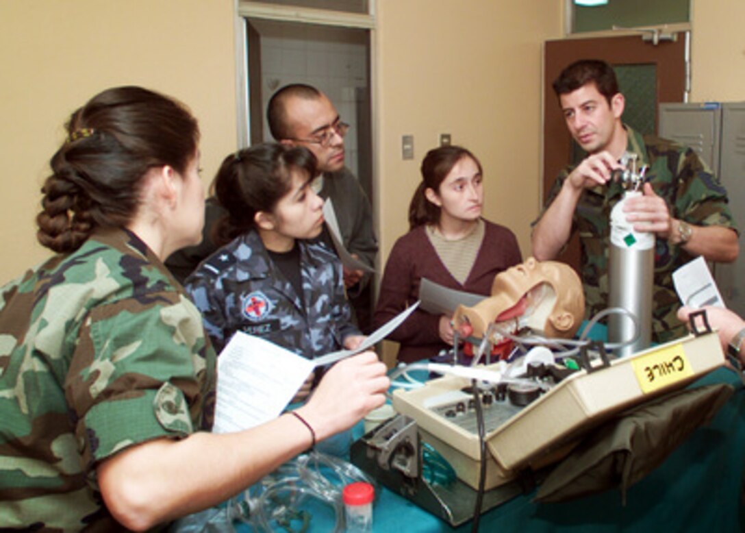 California Air National Guard Tech. Sgt. Bill Reynolds (right) explains the use of an oxygen bottle in basic airway procedures to Maia Perez, Andres Cortez and Cynthia Vasquez, of the Chilean Air Force, during a pre-hospital trauma response course in Santiago, Chile on Nov. 10, 2000. The course is part of medical and pre-trauma hospital response training exchange between the Chilean Air Force and the California Air National Guard. Reynolds is attached to the Guard's 146th Airlift Wing. 