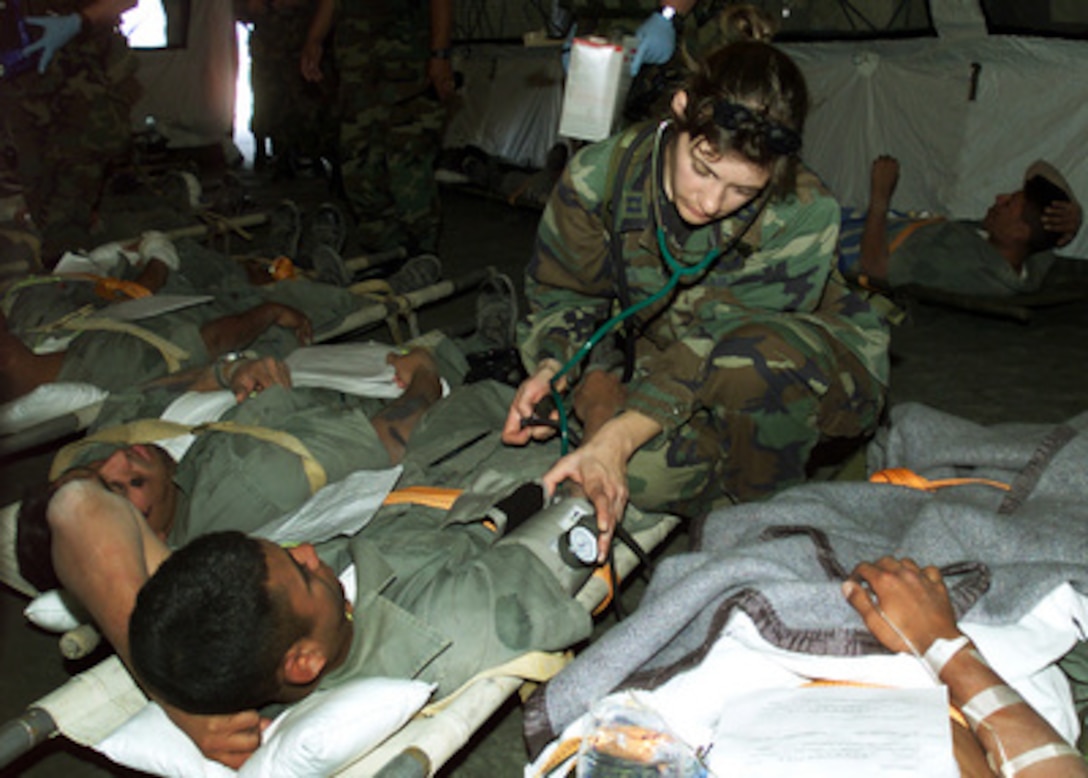 California Air National Guard Capt. Joanne Peros checks on a role-playing patient awaiting air evacuation during a mass casualty exercise in the Atacama Desert north of Santiago, Chile, on Nov. 15, 2000. The mass casualty evacuation exercise was part of a medical and pre-trauma hospital response training exchange between the Chilean Air Force, the California Air National Guard and the Wilford Hall Medical Center of Lackland Air Force Base, Texas. Peros is attached to the Guard's 146th Aeromedical Evacuation Squadron. 