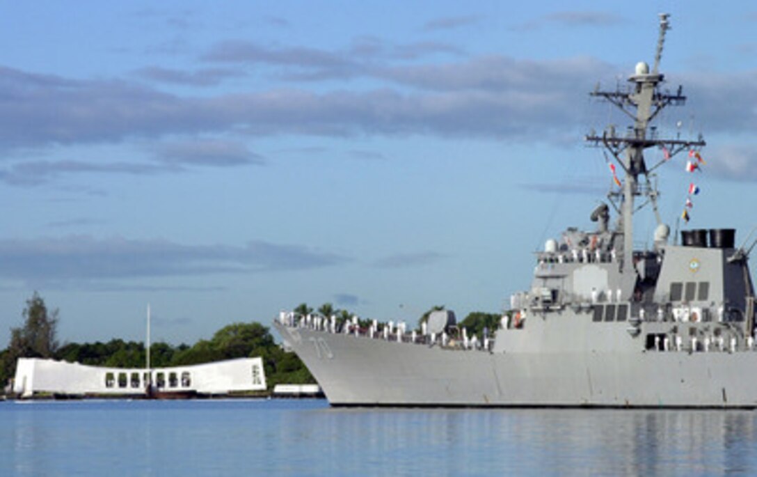 Sailors man the rail of the USS Hopper (DDG 70) as it parades by the USS Arizona Memorial in Pearl Harbor, Hawaii, on Dec. 7, 2000. The Arliegh Burke class destroyer is taking part in the ceremonies commemorating the 59th anniversary of the attack on Pearl Harbor. 