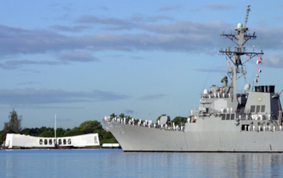 Sailors man the rail of the USS Hopper (DDG 70) as it parades by the USS Arizona Memorial in Pearl Harbor, Hawaii, on Dec. 7, 2000. The Arliegh Burke class destroyer is taking part in the ceremonies commemorating the 59th anniversary of the attack on Pearl Harbor. 