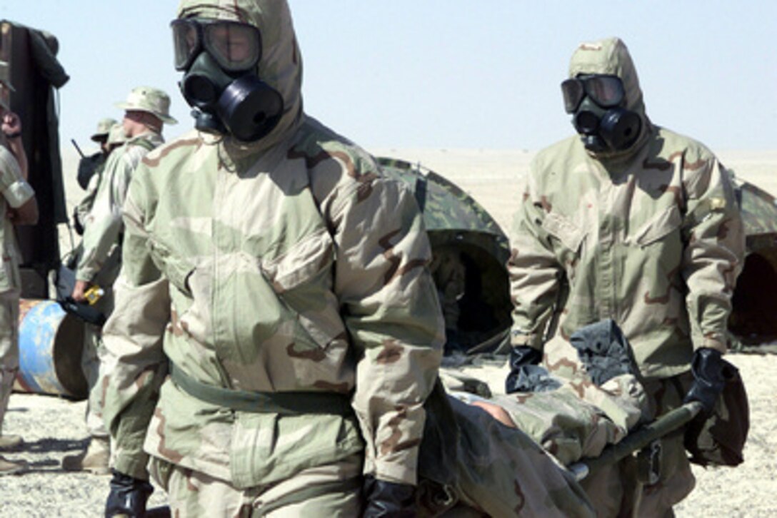Marines attached to the Enhanced Nuclear Biological Chemical decontamination section carry a simulated casualty to a decontamination site during nuclear biological chemical training on Nov. 19, 2000, at the Al Hamra Training Area in the United Arab Emirates. U.S. Marines from the 13th Marine Expeditionary Unit (Special Operations Capable) are deployed from the USS Tarawa (LHA 1) to the training area for Exercise Iron Magic. 
