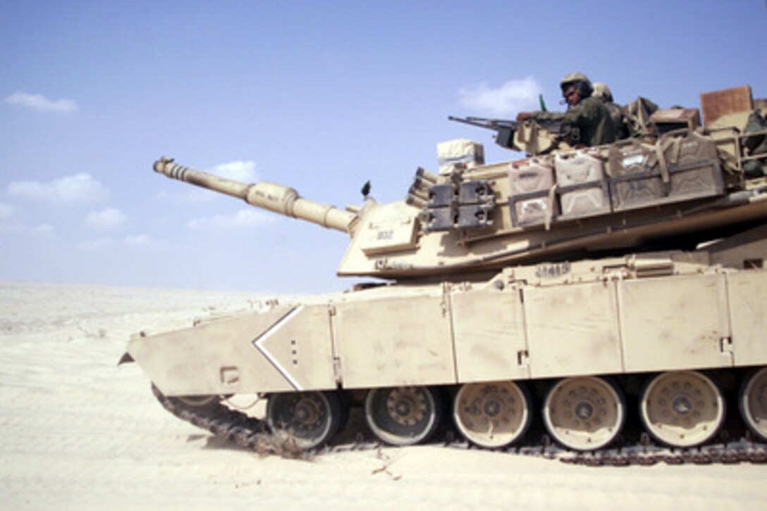 A U.S. Marine Corps M1-A1 Main Battle Tank prepares to move through a course of fire on Range 2 of the Al Hamra Training Area in the United Arab Emirates on Nov. 22, 2000. U.S. Marines from the 13th Marine Expeditionary Unit (Special Operations Capable) are deployed from the USS Tarawa (LHA 1) to the training area for Exercise Iron Magic. 