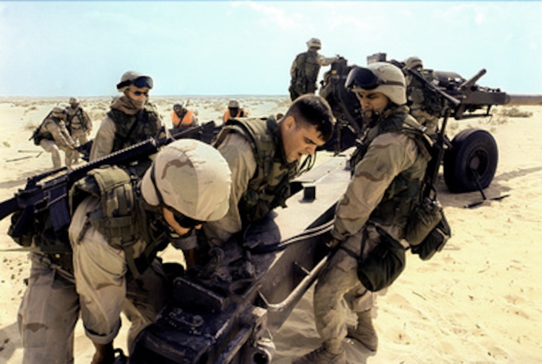 Cpls. J. E. Tunner, S.T. Nuthall and Lance Cpl. G. Lopez, of the 11th Marine Regiment, move a trail of their M-198 155 mm howitzer in preparation for a fire mission during live fire and maneuver training on Nov. 22, 2000, at the Al Hamra Training Area in the United Arab Emirates. U.S. Marines from the 13th Marine Expeditionary Unit (Special Operations Capable) are deployed from the USS Tarawa (LHA 1) to the training area for Exercise Iron Magic. 