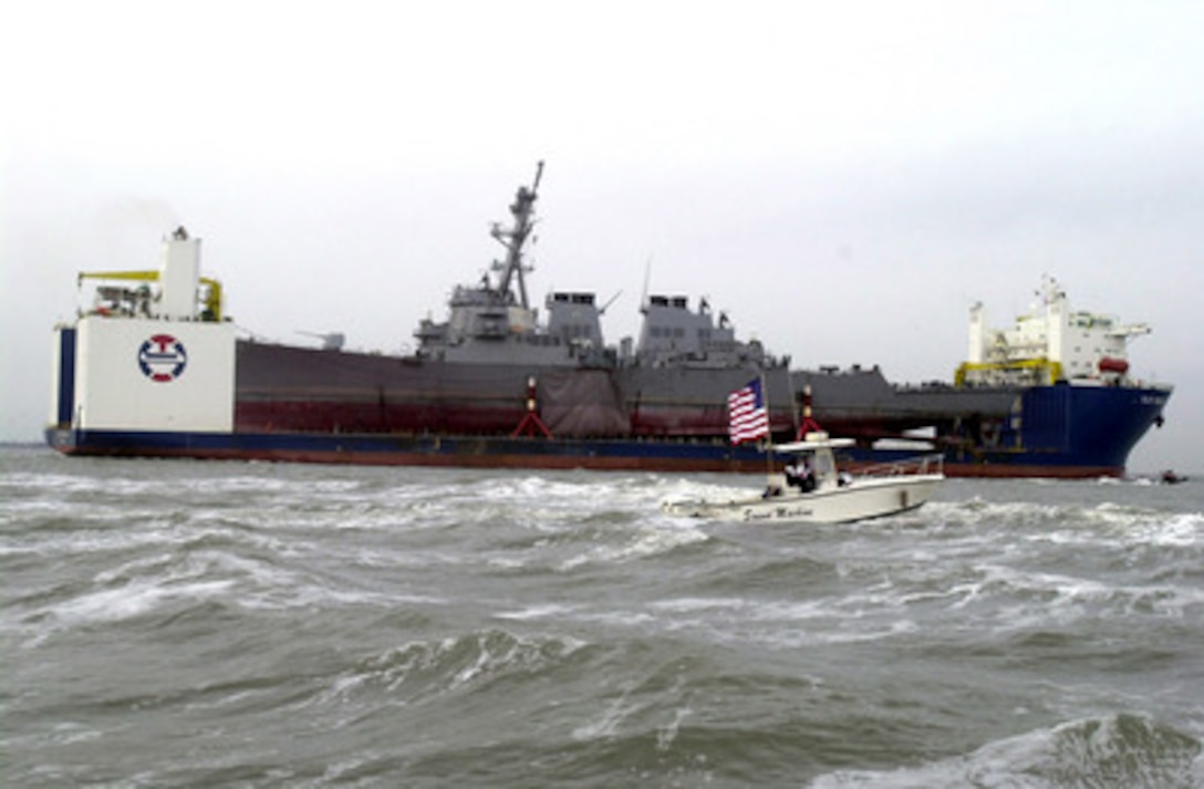 The USS Cole (DDG 67) arrives at the Ingalls Shipyard in Pascagoula, Miss., aboard the Norwegian commercial lift ship MV Blue Marlin on Dec. 13, 2000. The Arleigh Burke class destroyer was the target of a terrorist attack in the port of Aden, Yemen, on Oct. 12, 2000, during a scheduled refueling. The attack killed 17 crew members and injured 39 others. The ship will undergo repairs at the shipyard and return to service. 