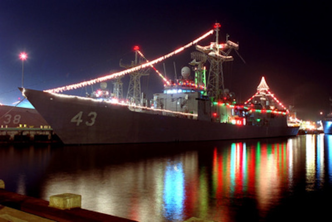 Red, green and white holiday lights outline the USS Thach (FFG 43) while it is moored at Naval Station 32nd Street in San Diego, Calif., on Dec. 20, 2000. The Thach is an Oliver Hazard Perry class guided missile frigate. 