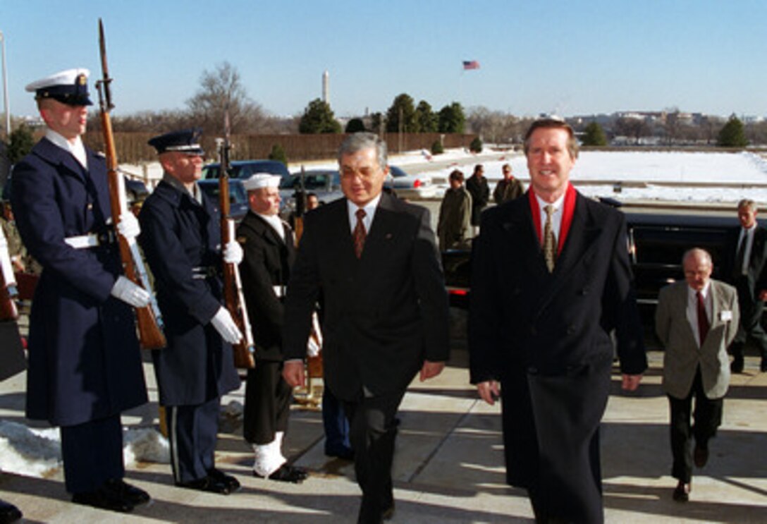 Tunisian Minister of Defense Mohamed Jegham (left) is escorted by Secretary of Defense William S. Cohen through an honor cordon into the Pentagon on Jan. 27, 2000. The two defense leaders will later meet to discuss a range of bilateral and regional security issues. 