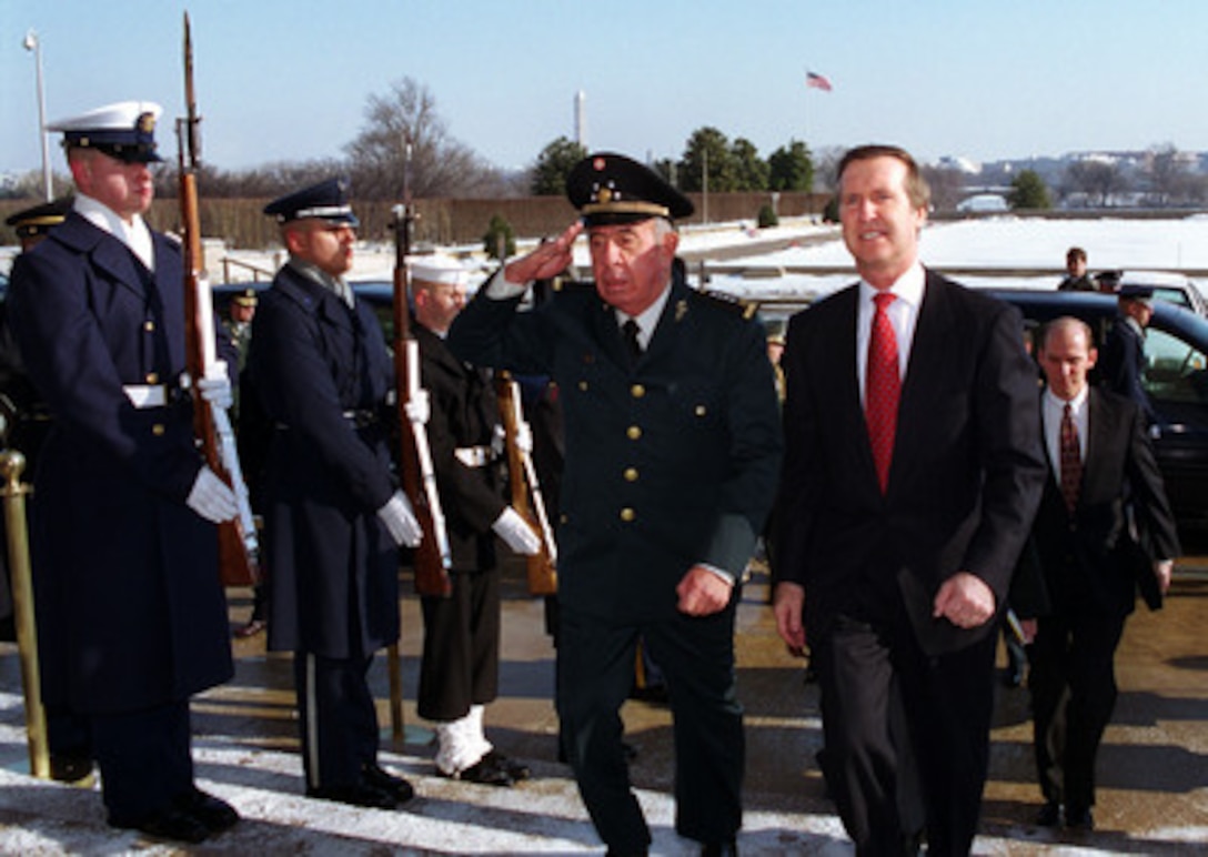 Secretary of Defense William S. Cohen (right) escorts Mexican Secretary of National Defense Gen. Enrique Cervantes through an honor cordon into the Pentagon on Jan. 31, 2000. Enrique and his delegation will meet with Cohen and his top advisors to discuss a range of bilateral and regional security issues. 