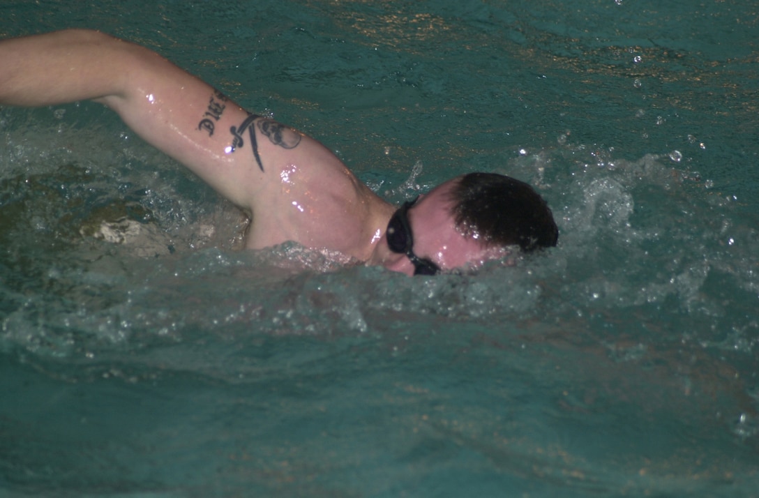 MARINE CORPS BASE CAMP LEJEUNE, N.C. - Sgt. Matt Kennedy, a student going through a course at the Combat Water Survival Swimming School, streaks through the water wall completing the 500 meter timed swim here Nov. 13. The Combat Water Survival Swimming School here trains the instructors who teach Marines how to stay alive if they find themself in water survival situation. (Official U.S. Marine Corps photo by Lance Cpl. Brandon R. Holgersen)