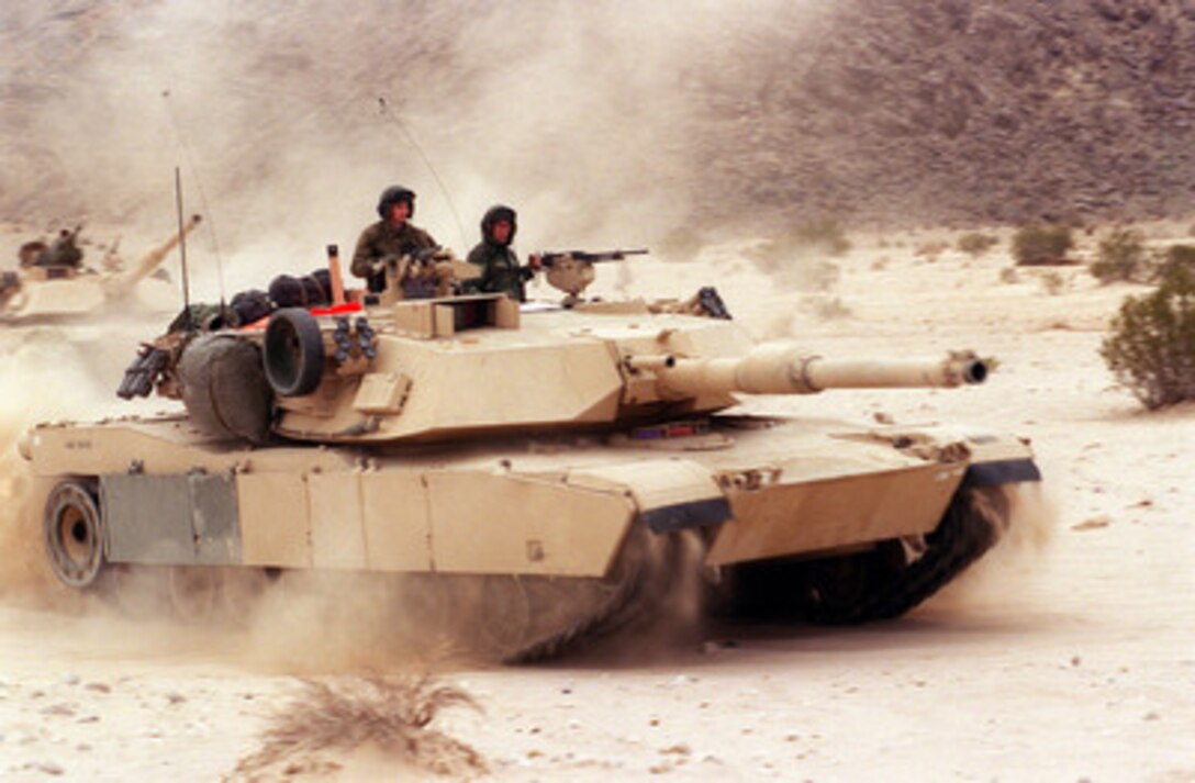 Marines of the 2nd Marine Division's 2nd Tank Battalion maneuver their M-1A1 main battle tanks during a Combined Arms Exercise at the Marine Corps Air Ground Combat Center, Twentynine Palms, Calif., on Feb. 1, 2000. The exercise is designed to involve all elements of the Marine Air Ground Task Force in a live fire, desert training environment. 