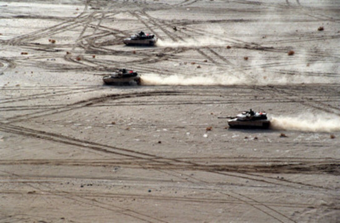 U.S. Marine Corps tanks leave plumes of dust as they race towards their primary objective during a Combined Arms Exercise at the Marine Corps Air Ground Combat Center, Twentynine Palms, Calif., on Feb. 1, 2000. Marines from the 2nd Marine Division's 2nd Tank Battalion took part in the exercise which is designed to involve all elements of the Marine Air Ground Task Force in a live fire, desert training environment. 