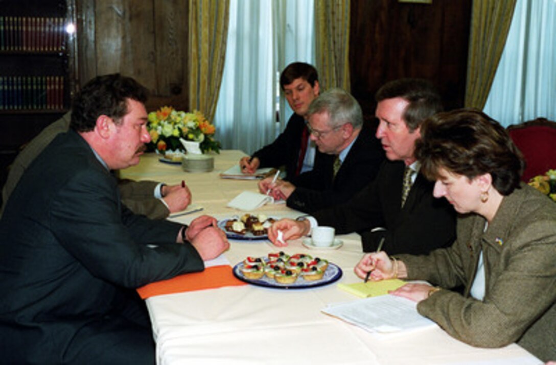 Ukraine Minister of Defense Colonel General Oleksandr Kuzmuk (left) meets with Secretary of Defense William S. Cohen (second from right) during the 36th Munich Conference on Security Policy in Germany on Feb. 5, 2000. Joining Cohen at the meeting are his Assistant Chief of Staff Paul R.S. Gebhard (center), Under Secretary of Defense for Policy Walter B. Slocombe (third from right) and the interpreter. 