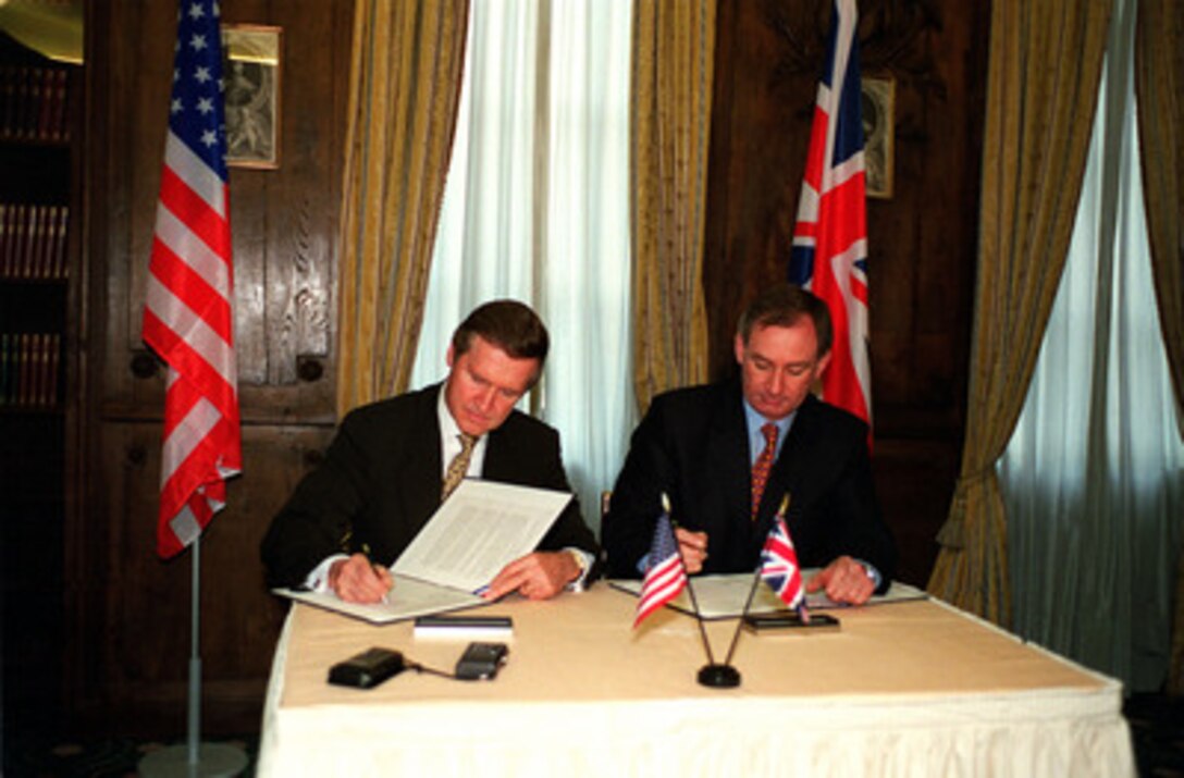 Secretary of Defense William S. Cohen (left) and his British counterpart, Secretary of State for Defence Geoffrey Hoon, sign a Declaration of Principles for Defense Equipment and Industrial Cooperation on Feb. 5, 2000, in Munich, Germany. The defense leaders are in Germany attending the 36th Munich Conference on Security Policy. The new pact mandates cooperation on such matters as coordination of military requirements and acquisition processes, export procedures, protection of national security and defense technology information, Trans-Atlantic industrial partnerships, research and development, and reciprocal defense trade. 