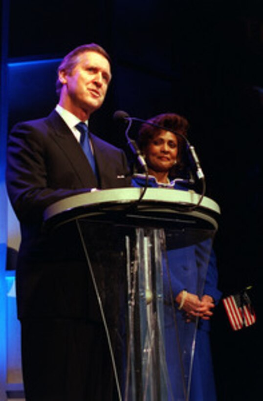 Secretary of Defense William S. Cohen, accompanied by his wife Janet, welcomes the audience to the Pentagon Pops in Washington, D.C., on Feb. 21, 2000. Cohen and his wife are hosting the Pentagon Pops, a musical salute with the theme of The Hero of the Century--the American G.I., at the Daughters of the American Revolution Constitution Hall. 