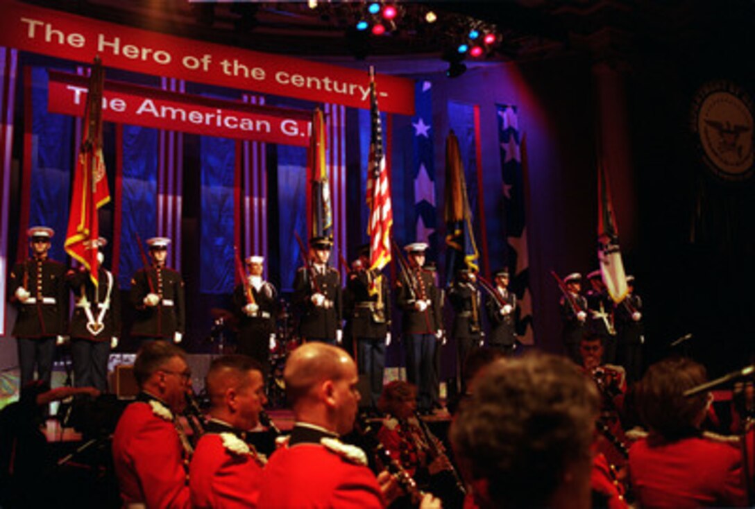 Color guards from each of the five armed services join the National Colors on stage as the U.S. Marine Corps Band (The President's Own) prepares to play the national anthem at the opening of the Pentagon Pops in Washington, D.C., on Feb. 21, 2000. Secretary of Defense William S. Cohen and his wife are hosting the Pentagon Pops, a musical salute with the theme of The Hero of the Century--the American G.I., at the Daughters of the American Revolution Constitution Hall. 