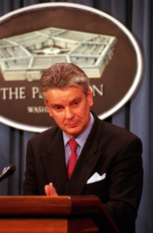 French Minister of Defense Alain Richard (right) listens to a reporter's question during a joint press briefing with Secretary of Defense William S. Cohen (left) in the Pentagon on Feb. 23, 2000. 