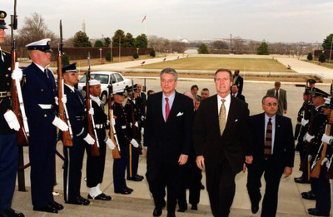 French Minister of Defense Alain Richard (left) is escorted by Secretary of Defense William S. Cohen (right) through an armed forces honor cordon into the Pentagon on Feb. 23, 2000. 