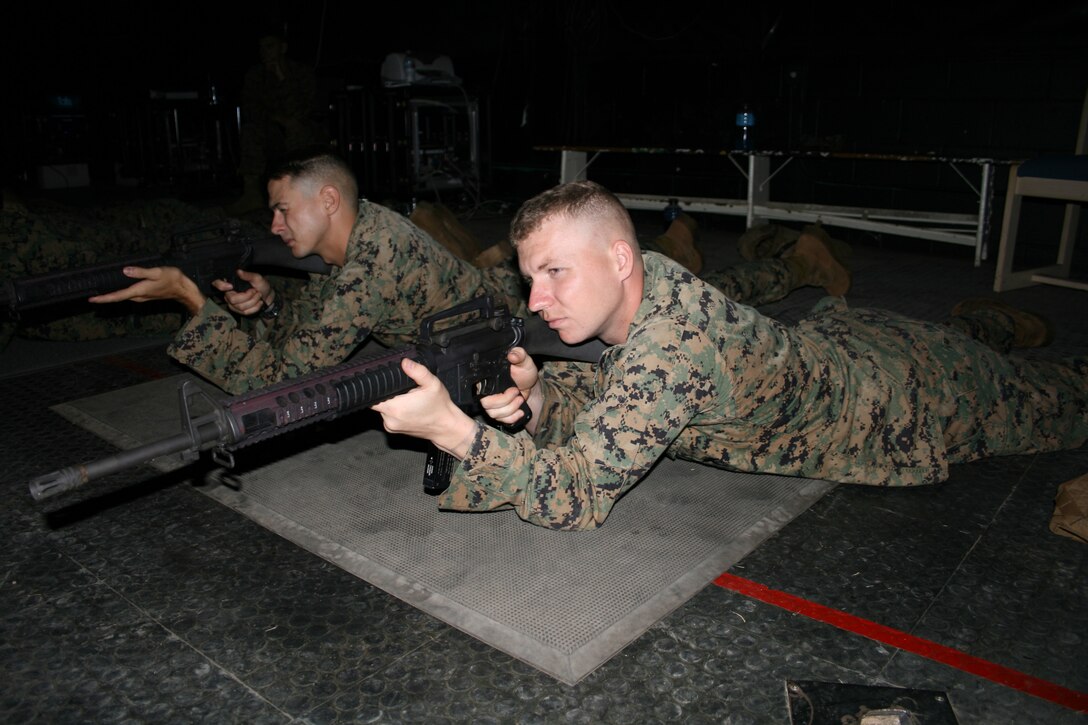 Cpl. Brent Lee (right) and Lance Cpl. Jason Metrolis (left), training NCOs, MARFORPAC, fire modified M-16 A2 service rifles during a recent trip to 3rd Marine Regiment's ISMT.