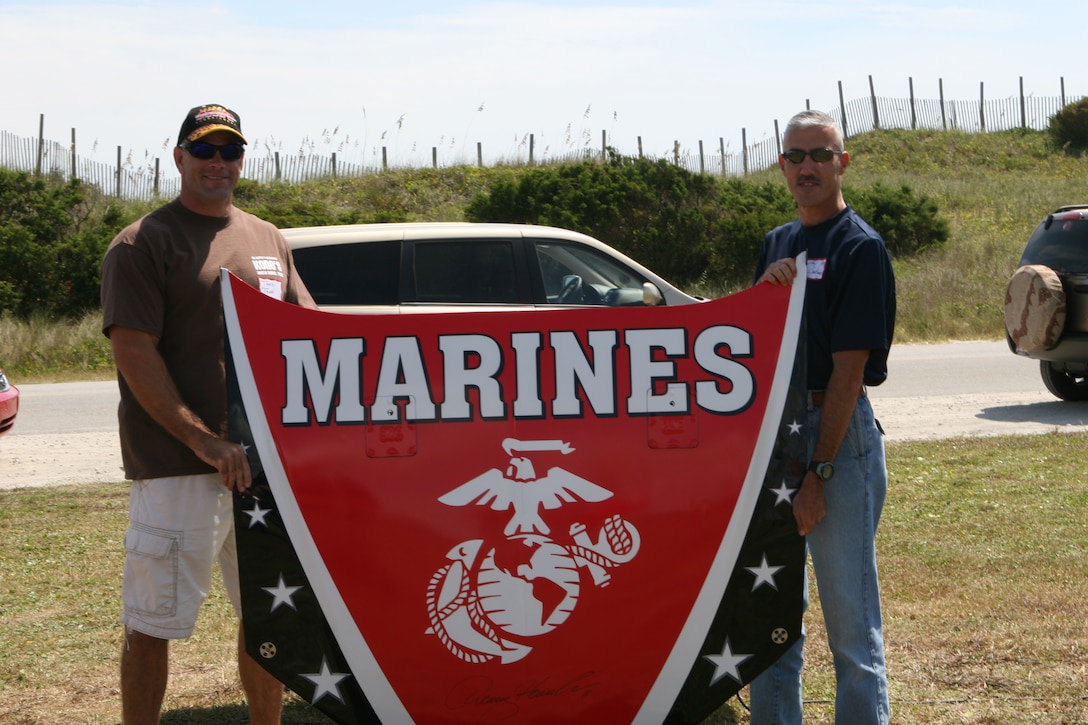 MARINE CORPS BASE CAMP LEJEUNE, N.C. (Sept. 8, 2007) -- Lt. Col. Thad R. Trapp (left) and Sgt. Maj. Jose L. Santiago pose with a car hood given to 2nd Battalion, 9th Marine Regiment, 2nd Marine Division, at the battalion?s family day at Onslow Beach Sept. 8. The hood was given to the battalion courtesy of Joe Gibbs Racing Team and was signed by NASCAR driver Denny Hamlin.