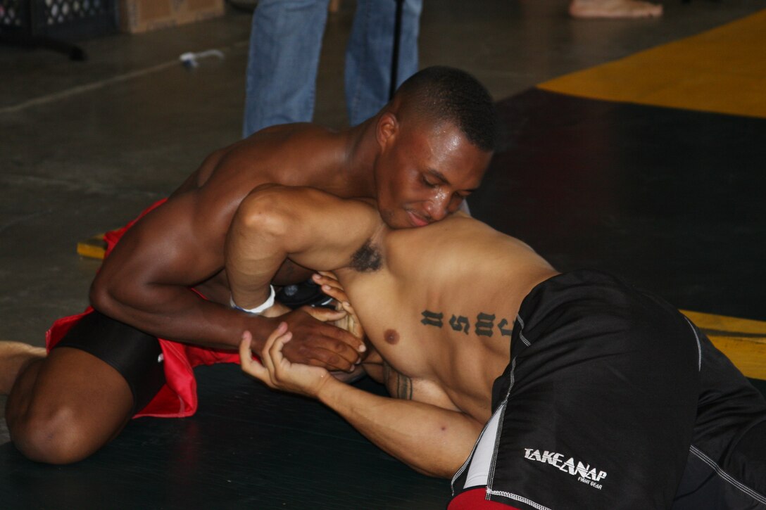 David Dew, 155-pound Fight Club 29 member, applies a choke to an opponent during the Grapplers Tournament Extreme at the Army National Guard armory in San Bernardino, Calif., Sept. 27, 2008. Dew, a junior middleweight fighter, fought three opponents and walked away with a gold medal. Two other Fight Club 29 members earned gold that day.