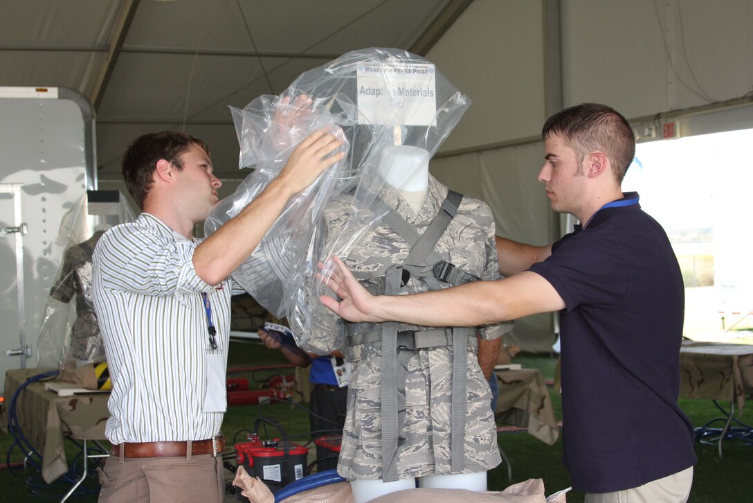 Team leader Nathan Ernst and team member Mike Gorski of Adaptive Materials Inc., prepare their prototype power system for connection to a power draw computer system for the 2008 Director Defense Research and Engineering Wearable Power Prize competition at Del Valle Field aboard the Combat Center Sept. 28.