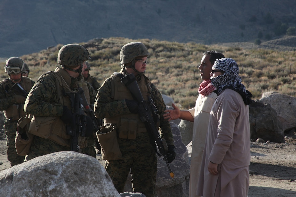 Marines with 3rd Marine Regiment talk to role players as an aggressive crowd masses outside their Forward Operating Base during a mass casualty exercise at Marine Corps Mountain Warfare Training Center Bridgeport, Calif., Oct. 7, 2010. ::r::::n::