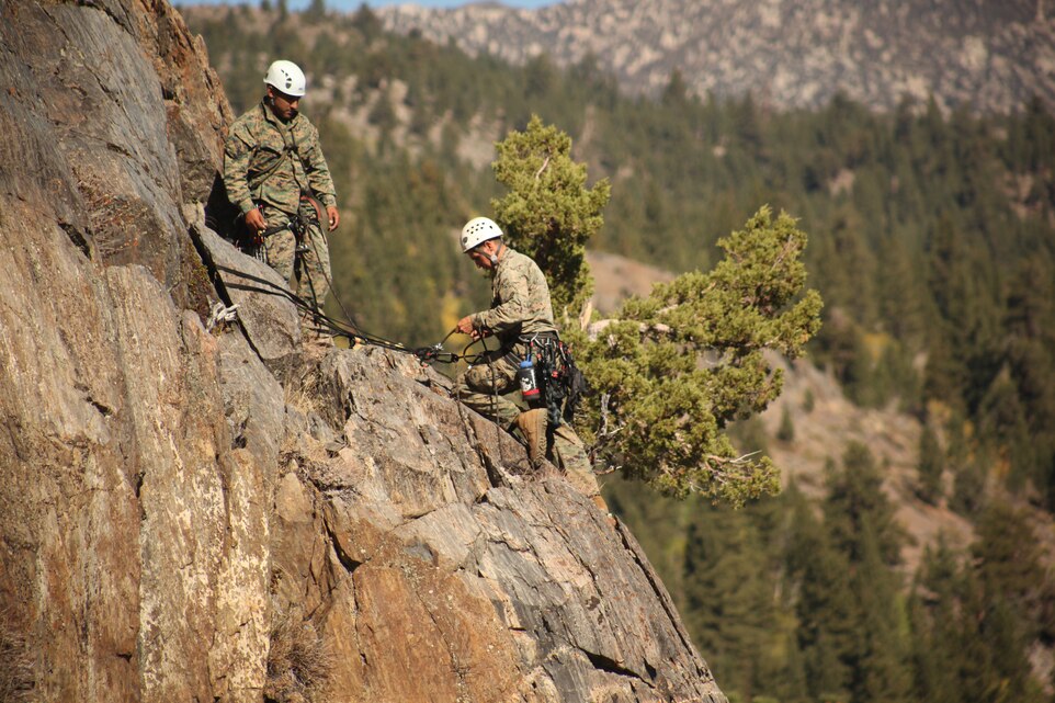 Two Marines with 2nd Battalion, 5th Marine Regiment conduct a two-party-climb while scaling an 150 ft. wall Toiyabe National Forest during the Assault Climber’s Course Oct. 15.::r::::n::