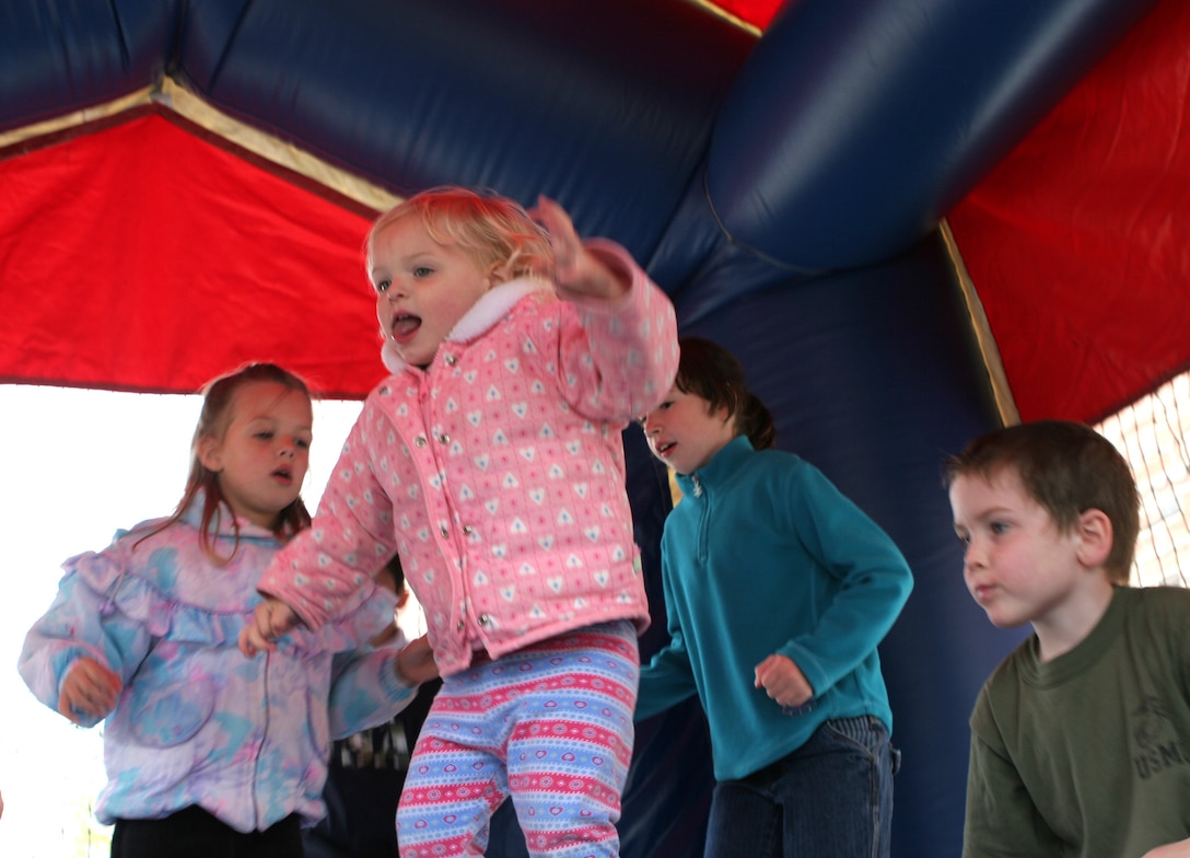 MARINE CORPS BASE CAMP LEJEUNE, N.C. ? Children of Marines attached to II Marine Expeditionary Force Headquarters Group, II MEF, jump inside an air-cushioned tent during II MHG family day and picnic April 17.  The fun-filled event brought out more than 150 Marines, sailors and their families.  Many of those in attendance have loved ones deployed with the unit in support of Marine operations in Iraq.