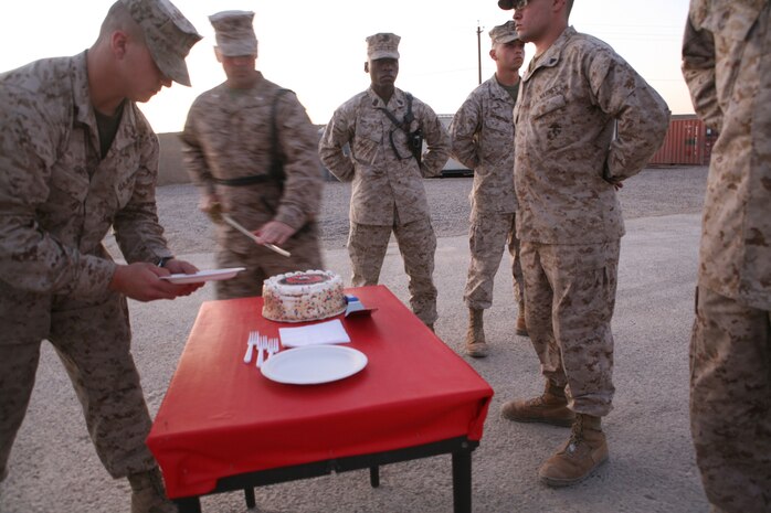 Lt. Col. Chris Hastings, commanding officer, 1st Battalion, 4th Marine Regiment, Regimental Combat Team 1, cuts the first piece of ceremonial birthday cake. Marines with the battalion took part in a Marine Corps birthday ceremony Nov. 10 at Camp Baharia in Fallujah, Iraq.