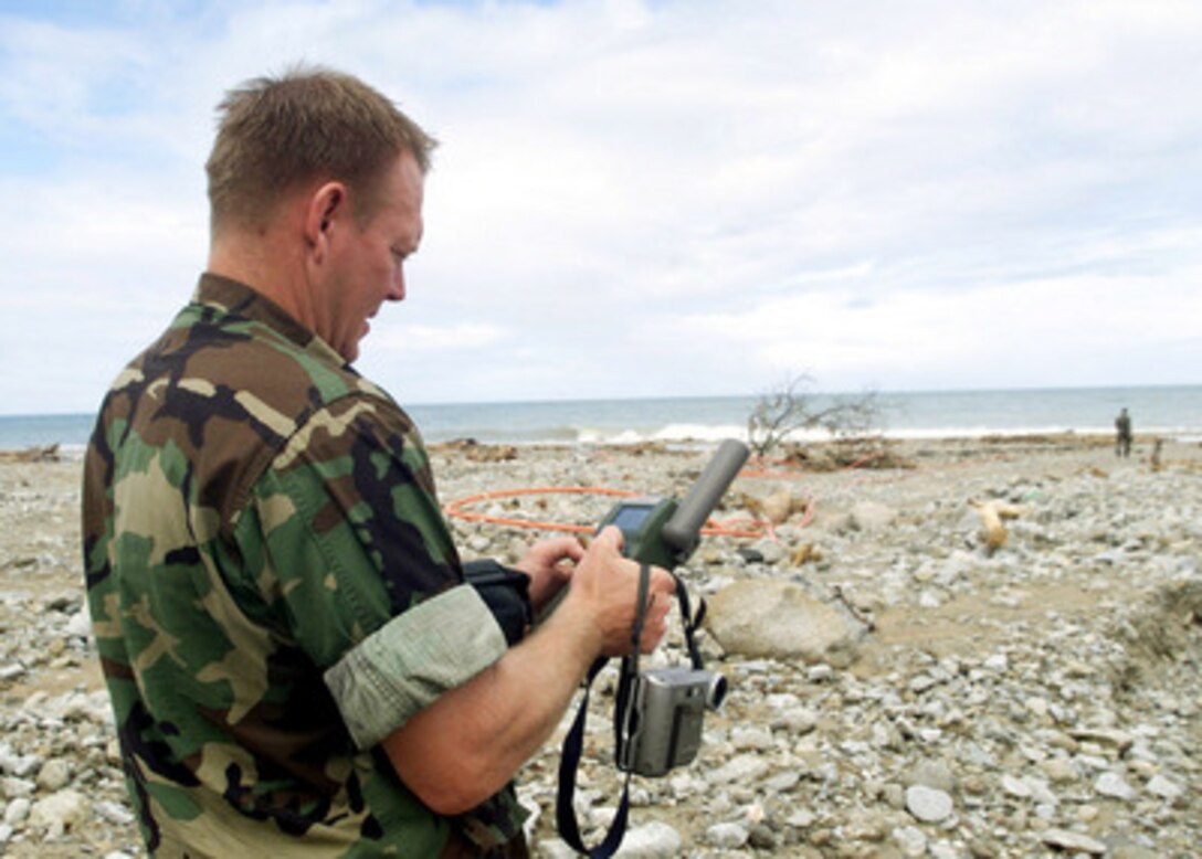 Navy Chief Warrant Officer Paul Patterson uses a global positioning system receiver to calculate coordinates for a potential amphibious landing zone at a beach near Makuto, Venezuela, on Jan. 3, 2000. Patterson is an engineering reconnaissance team member for Joint Task Force Fundamental Response. Nearly 100 U.S. service men and women are delivering supplies and providing humanitarian assistance to flood and mud slide survivors in Venezuela as part of Operation Fundamental Response. 
