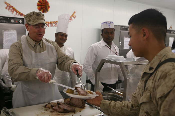 Secretary of the Navy Donald C. Winter serves Marines turkey to Marines with 1st Battalion, 4th Marine Regiment, Regimental Combat Team 1 at the dining facility on Camp Baharia in Fallujah, Iraq, Nov. 27. (Official Marine Corps photo by Cpl. Chris T. Mann)::r::::n::(Released)::r::::n::