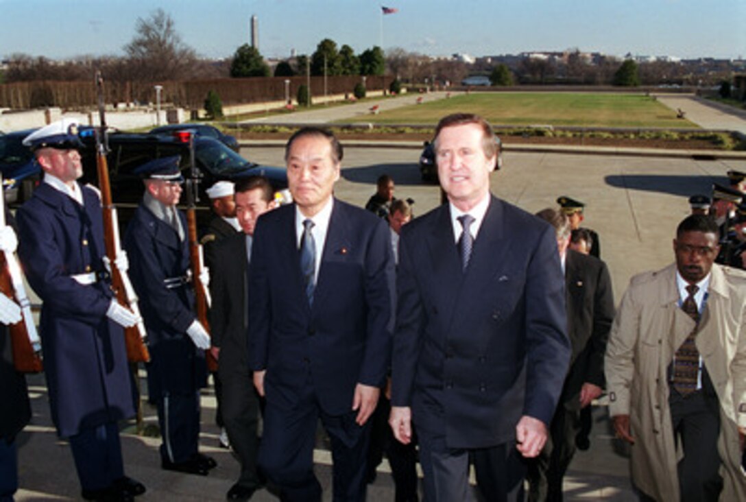 Secretary of Defense William S. Cohen (right) escorts Director General Tsutomu Kawara (left), of the Japan Defense Agency, through an honor cordon into the Pentagon on Jan. 5, 2000. The two defense leaders will meet in private and with senior advisors, to review a range of regional and global security issues of interest to both nations. 
