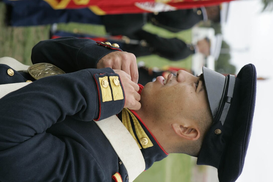 Sgt. David M. Williams fixes his collar before marching on the 11 Area Parade Field for the Marine Corps birthday pageant Nov. 9. Williams wore the Marine uniform from the Mexican-American War.