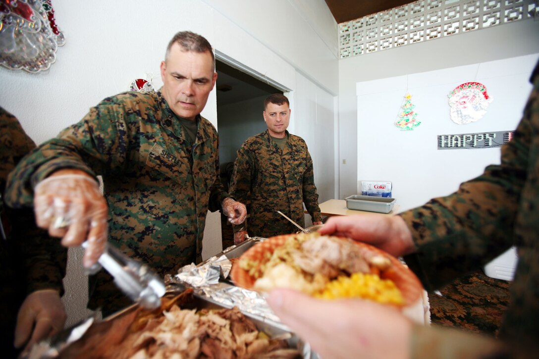 MARINE CORPS BASE, CAMP H.M. SMITH, Hawaii (Nov. 21, 2007) -- Mastery Gunnery Sgt. Ernest Shifflet, the ammunitions plans chief here, piles turkey onto a Marines heaping plate of food during the staff-noncommissioned officers Thanksgiving Day Luncheon Nov 21.  Senior enlisted Marines at U.S. Marine Corps Forces, Pacific shared the spirit of Thanksgiving by treating their Marines to turkey and all the trimmings as a way to say thanks for all their hard work.