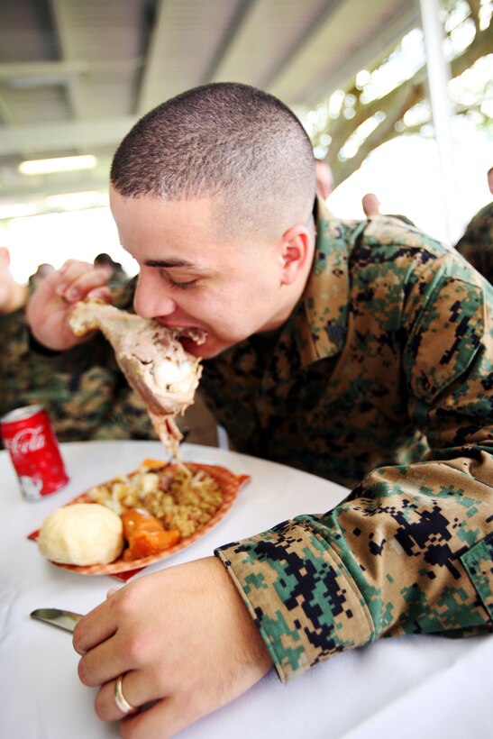 MARINE CORPS BASE, CAMP H.M. SMITH, Hawaii (Nov. 21, 2007) -- Sgt. Carlos Crespo, a G-4 operations noncommissioned officer in charge here, attacks a turkey leg during the staff-noncommissioned officers Thanksgiving Day Luncheon Nov 21.  Senior enlisted Marines at U.S. Marine Corps Forces, Pacific shared the spirit of Thanksgiving by treating their Marines to turkey and all the trimmings as a way to say thanks for all their hard work.