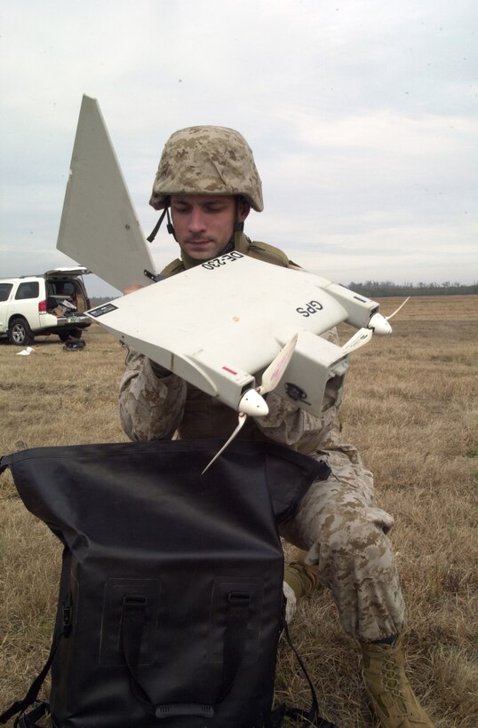 MARINE CORPS BASE CAMP LEJEUNE, N.C. - Corporal Robert Broome, a forward scout observer with Company C, 2d Light Armored Reconnaissance Battalion, assrmbles the Dragon Eye unmanned aerial vehicle during a pre-flight functions check at Tactical Landing Zone Falcon Jan. 12. Broome participated in the five-day Dragon Eye course with sole instructor Sgt. Michael Hartzfeld, Jan. 10 through 14, to learn how to properly operate the remote controlled piece of surveillance equipment. (Official Marine Corps photo by Lance Cpl. Matthew K. Hacker)