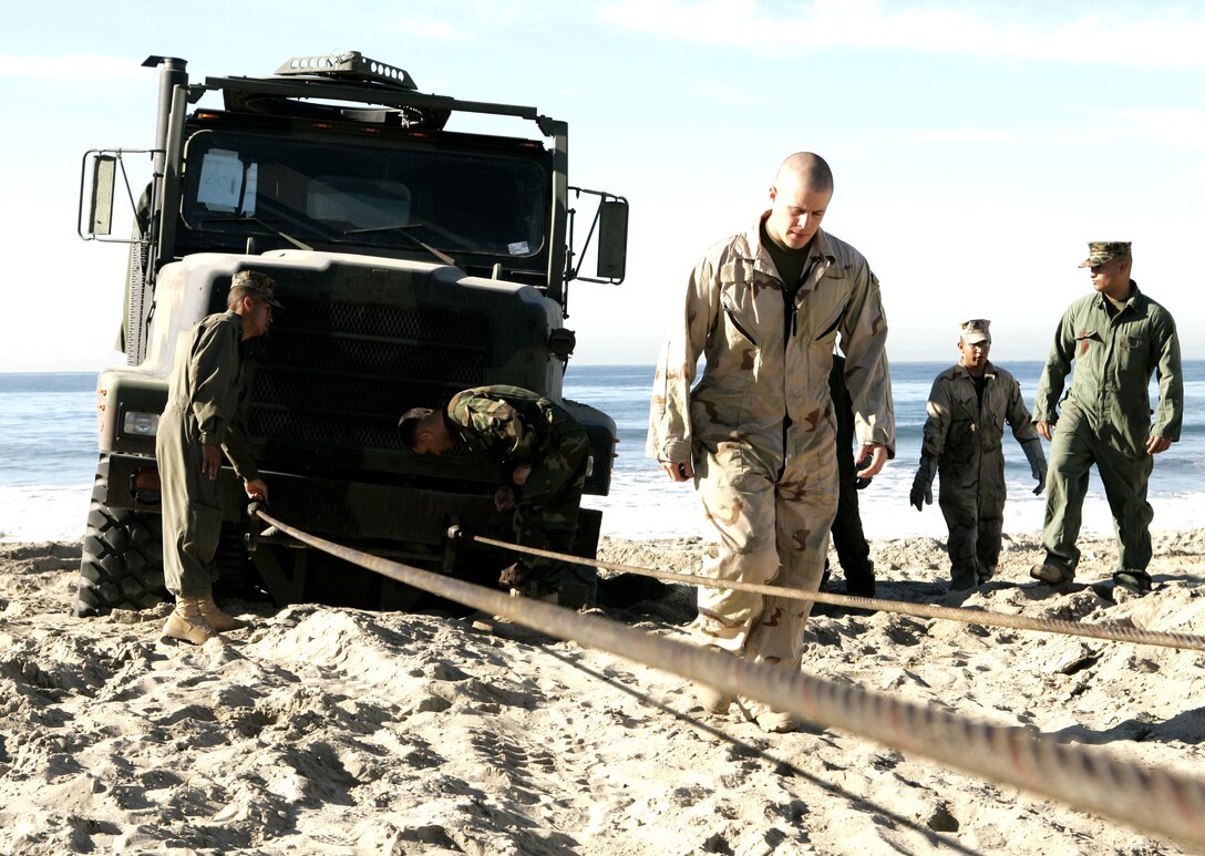 Motor transportation Marines recover a seven-ton truck after getting it stuck in the sands on Camp Pendleton?s beaches Nov. 17. The recovery was part of a vehicle recovery course designed to train Marines to recover and retain vehicles in Iraq.