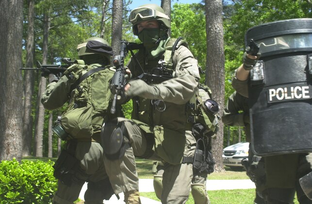 MARINE CORPS BASE CAMP LEJEUNE, N.C. - Marines with the Special Reaction Team storm a house during regular training here May 2. The mission of the team is a simple one, to plan for rehearse and conduct tactical operations and resolve high risk incidents with minimum force. The team is selected from the best military policemen aboard the base, which must have the prerequisite of expert in rifle and pistol, a first class physical fitness test and have at least a year of time on the road. (Official U.S. Marine Corps photo by Lance Cpl. Brandon R. Holgersen)(released)