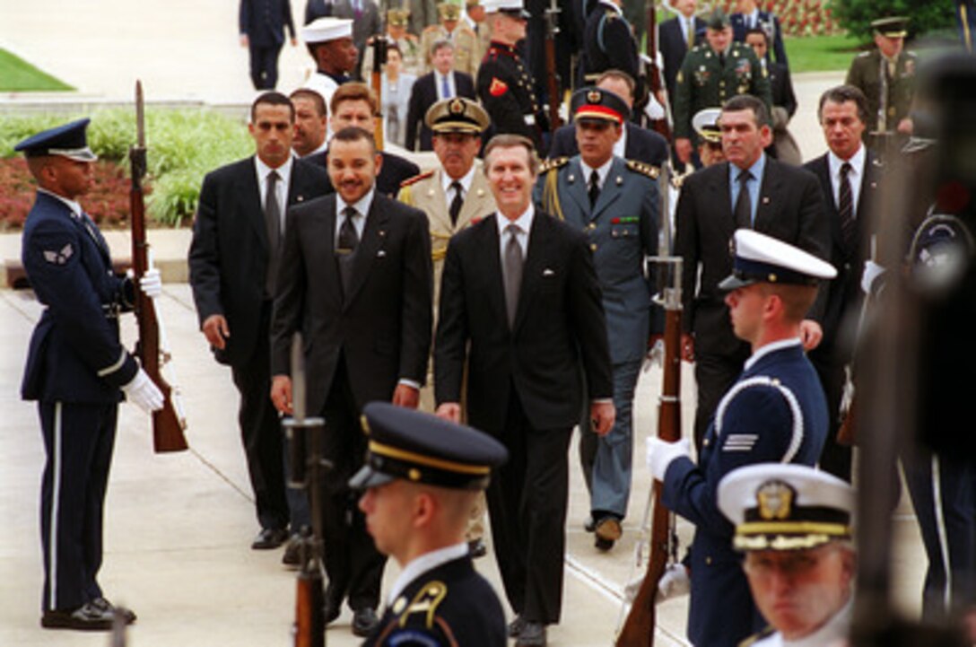 His Majesty King Mohamed VI of Morocco (left front) is escorted through a cordon by Secretary of Defense William S. Cohen (center) and into the Pentagon on June 21, 2000. The two men will meet to discuss a range of security issues, both regional and global, of mutual interest to both nations. 
