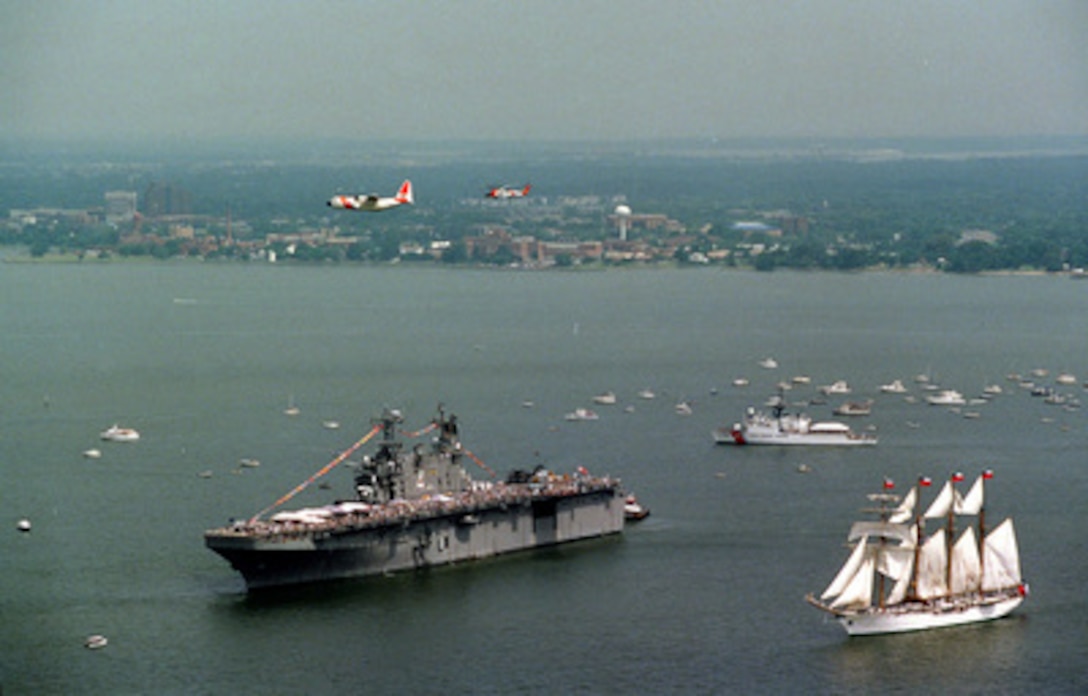 A tall ship passes by the USS Nassau (LHA 4) during the Operation Sail 2000 parade of sail in Hampton, Va., on June 16, 2000. The program is designed to promote good will and cooperation between the U.S. and foreign navies while celebrating global maritime heritage. 