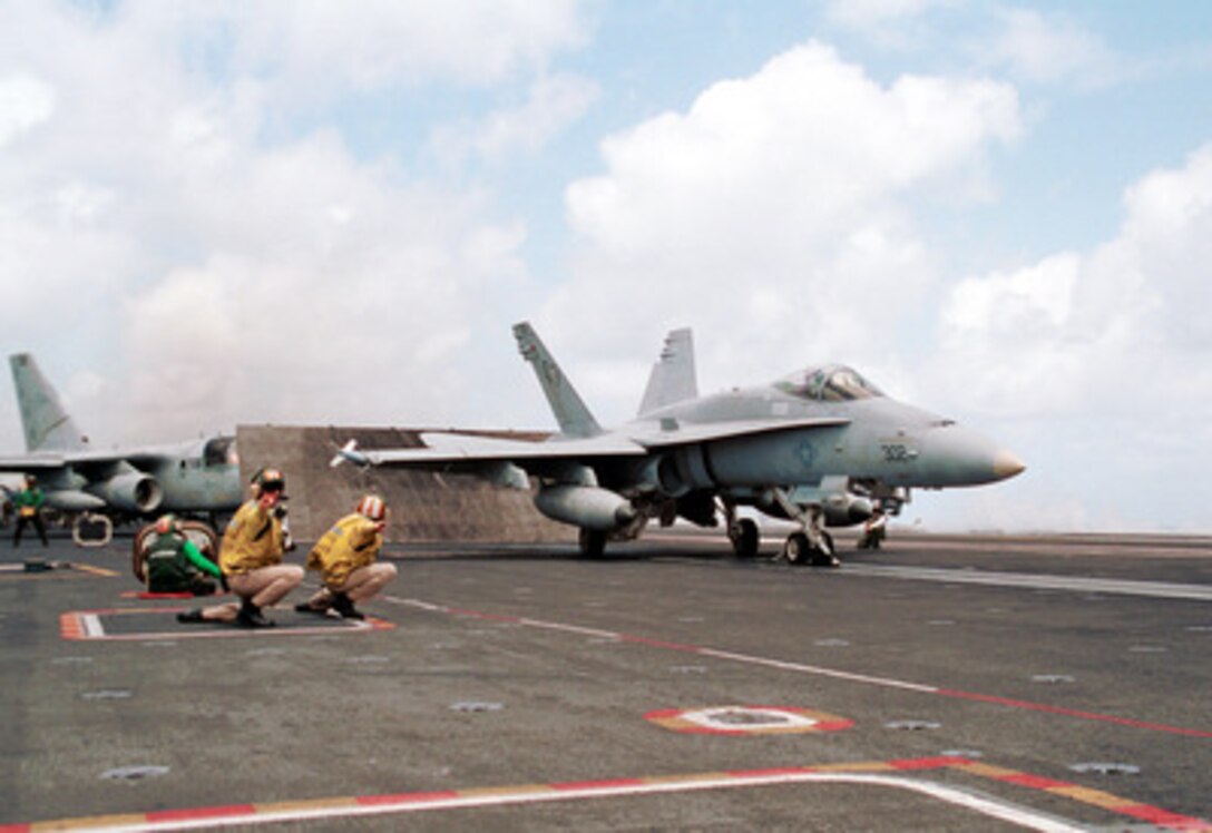 A U.S. Navy F/A-18 Hornet launches from the flight deck of the USS George Washington (CVN 73) while the ship operates off the coast of Puerto Rico on June 26, 2000. The Hornet, loaded with inert weapons, will conduct bombing runs on the training range on the island of Vieques. The George Washington Battle Group is deployed on a scheduled six month deployment. 
