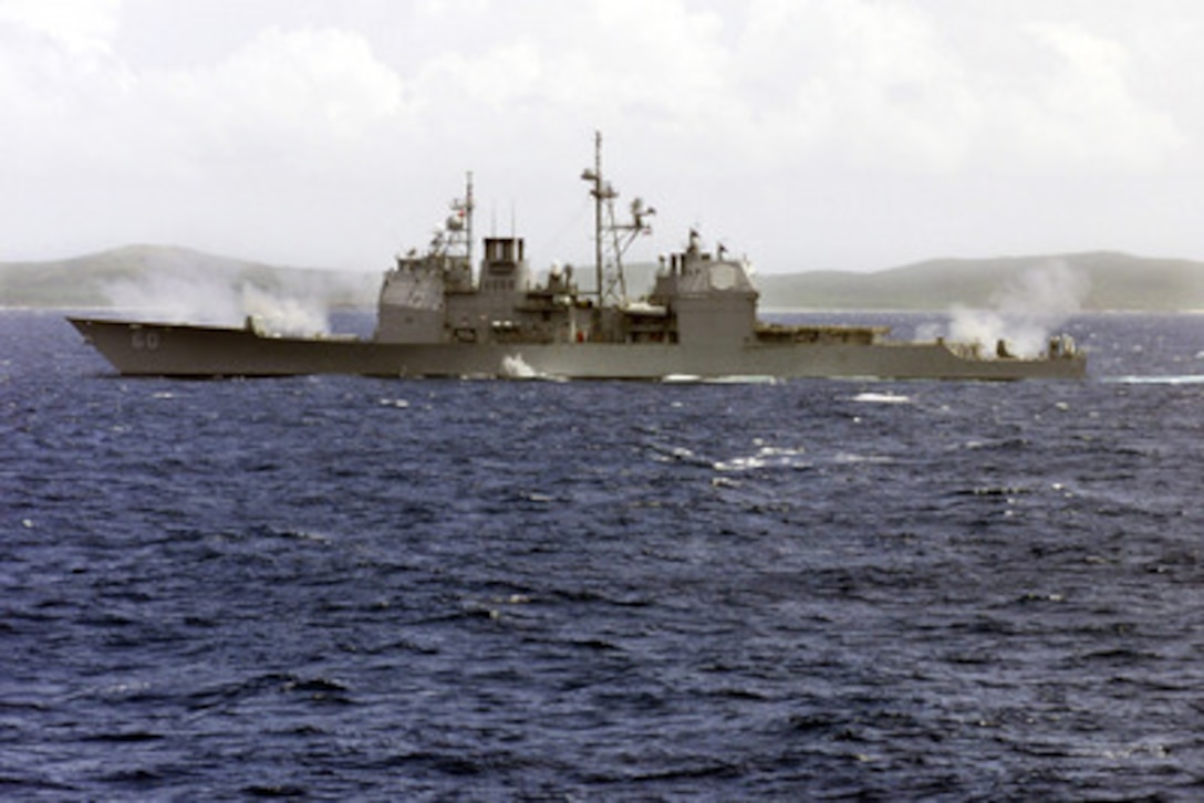 The USS Normandy (CG 60) fires its five inch guns at the training range on Vieques, Puerto Rico, on June 26, 2000. The Normandy is deploying as part of the George Washington Battle Group on scheduled six month deployment. The Ticonderoga class cruiser is home ported in Norfolk, Va. 