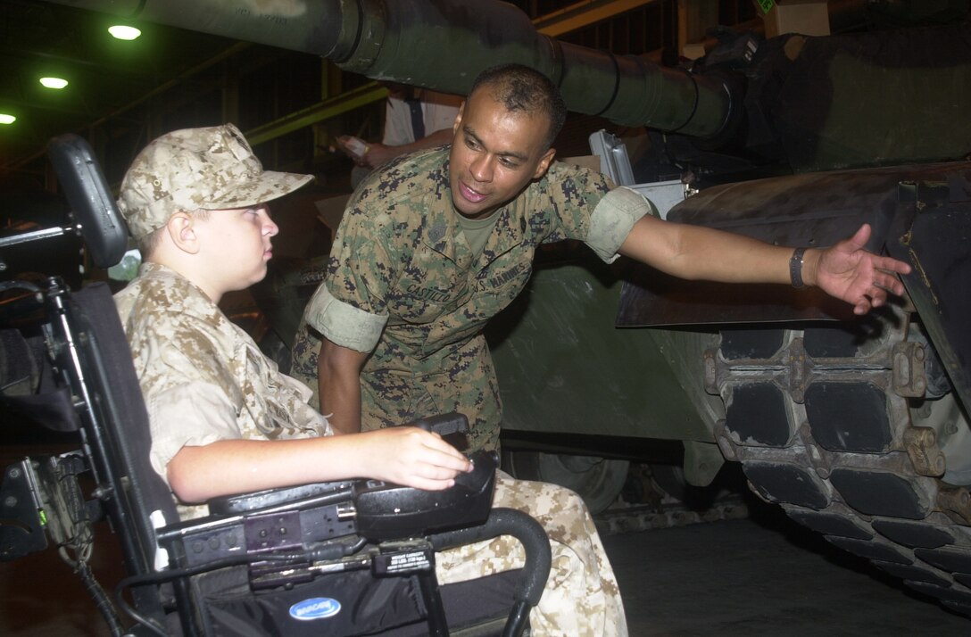 MARINE CORPS BASE CAMP LEJEUNE, N.C. - Hunter Box (left) receives over view of the parts of an M1A1 Abrams main battle tank by Master Sgt. Ishmael Castillo, a tank leader with Company C, 2d Tank Battalion, 2d Marine Division. Box, 11, from Dunlap, Tenn., joined the ranks of the few and the proud June 28 after being bestowed the title of Honorary Marine by Maj. Gen. Robert Dickerson, the Marine Corps Base commanding general at building one. (Official U.S. Marine Corps photo by Lance Cpl. Brandon R. Holgersen)