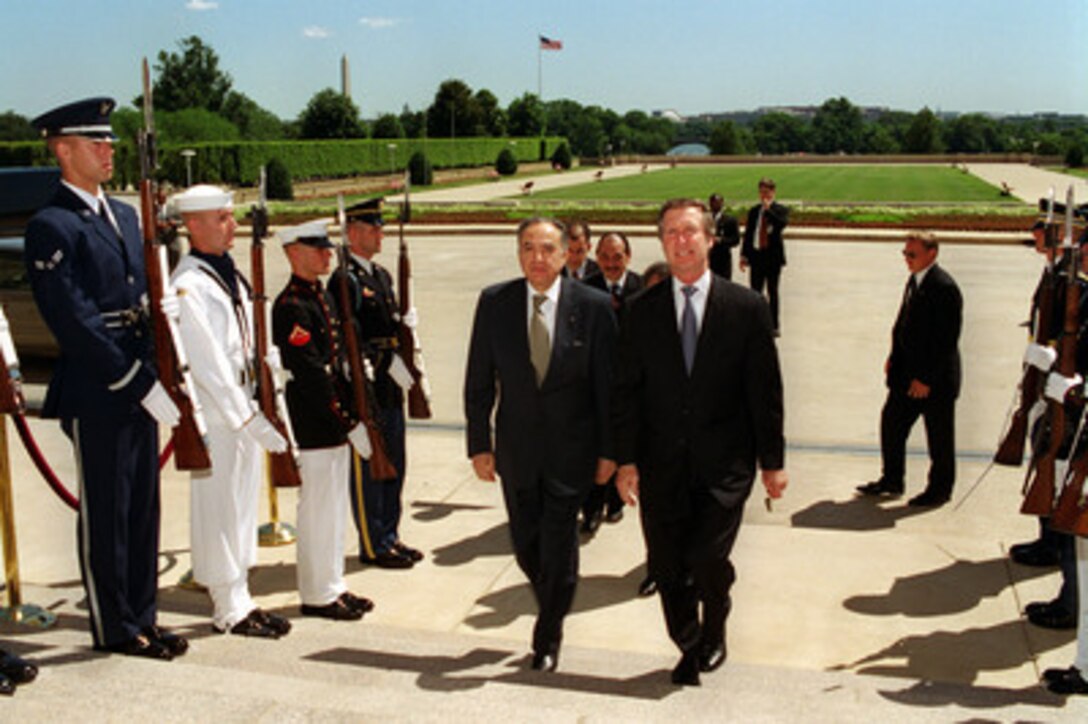 Secretary of Defense William S. Cohen (right) escorts Tunisian Minister of Foreign Affairs Habib Ben Yahia through a joint service honor cordon and into the Pentagon on July 7, 2000. Cohen and his senior policy advisors will meet with Ben Yahia to discuss a range of regional security issues. 