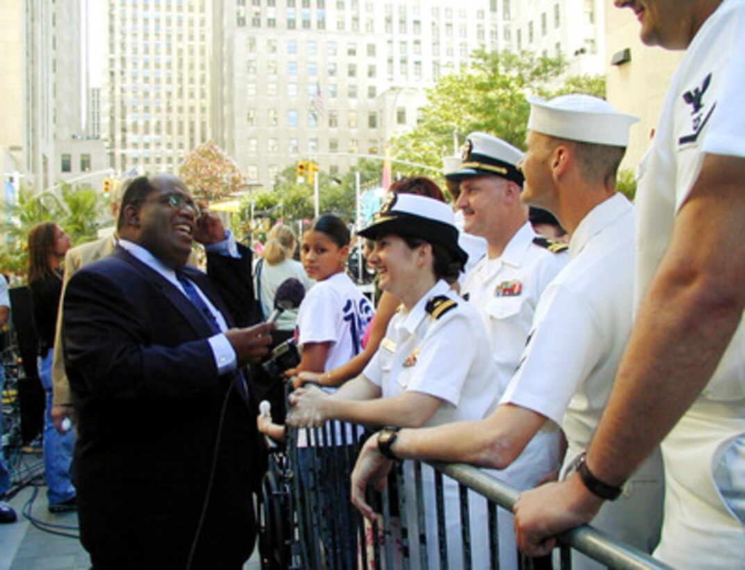 NBC's Today Show personality Al Roker chats with U.S. Navy Lt. Christa Sturbois and other sailors during a live broadcast of the popular morning show from Rockerfeller Center in New York City on July 7, 2000. Sturbois is one of over 25,000 international sailors and Marines from 20 countries in New York for International Naval Review 2000, a week-long event billed as a Celebration of Seapower for the Millennium. Sturbois is from Grandview, Ohio. 