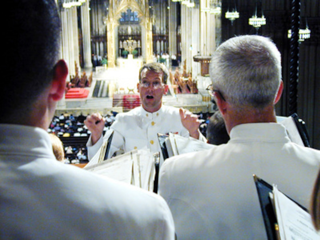 Chief Musician Keith D. Hinton directs the U.S. Navy Sea Chanters Chorus during a mass at St. Patrick's Cathedral in New York City on July 8, 2000. Over 25,000 international sailors and Marines from 20 countries in New York for International Naval Review 2000, a week-long event billed as a Celebration of Seapower for the Millennium. The Sea Chanters performed during a mass for the blessing of the fleet, signaling the end of the International Naval Review. 