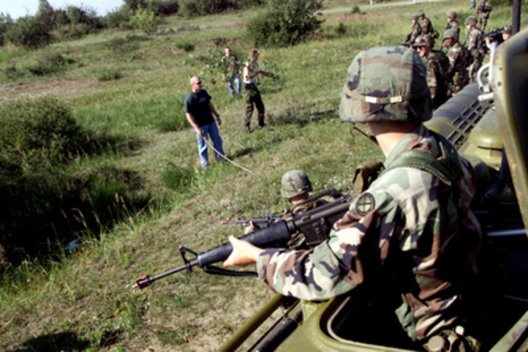 Swedish soldiers role-play as locals to harass U.S. soldiers from the 2nd Battalion, 130th Infantry, Illinois Army National Guard after they inadvertently entered a simulated minefield at a checkpoint during Exercise Peaceshield 2000 in Yavoriv, Ukraine, on July 15, 2000. Approximately 1000 soldiers from 22 countries are taking part in the peacekeeping training exercise at the Partnership for Peace Training Center at Yavoriv. Members of the Swedish Armed Forces International Command are instructing and evaluating mine awareness procedures for troops in the field during Peaceshield. 
